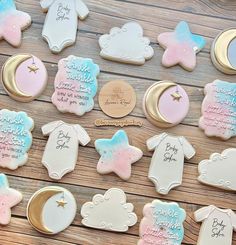 baby shower cookies decorated with pink, blue and white icing on a wooden table