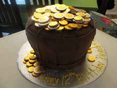 a birthday cake with lots of gold coins on it