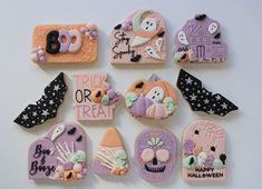 decorated cookies are arranged in the shape of heart, skull, ghost, and tombstones