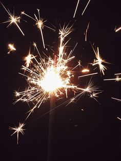 a close up of a sparkler on a black background