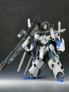 a white and blue robot standing in front of a black background