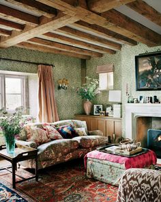 a living room filled with furniture and a fire place in the middle of a room