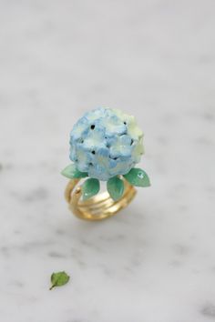 Hydrangea Blue Ring"Bloom" collection by 9AM . GOOD AFTER NINE"Let Hydrangea ring express your appreciation"When you feel so thankful with your love one, it mean so much to express your feeling to make them know.Hydrangea ring come in the various color (Blue/Yellow, Pink/Yellow, Purple).Fill your feeling of appreciation with this beautifully designed ,fulfill with color detail by Hand painted with care ,High Gloss Enameling with detailed craftsmanship and also comfortable to wear in every moment Hydrangea Accessories, Pretty Items, Bug Jewelry, Hydrangea Blue, Mirror Cake, Dope Jewelry Accessories, Enamel Jewellery, Purple Ring, Hydrangea Purple