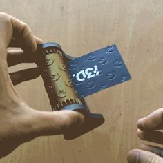 two hands holding up a card with the word q2 on it and another hand reaching for it