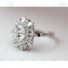 an oval cut diamond ring on a white background