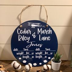 a wooden sign that reads cedar marsh, riley & lane jones on it next to cotton balls and succulents