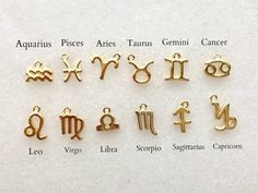 zodiac symbols are shown in gold on a white surface with other zodiacs and their names