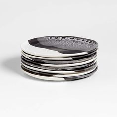 black and white plates stacked on top of each other in front of a white background