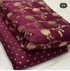 two pieces of purple fabric with gold flowers on the bottom and one piece is folded in half