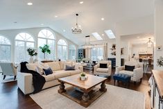 a living room filled with furniture and large windows