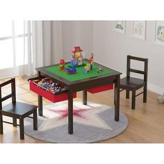 a child's table and chairs set up in a playroom with toys on the floor