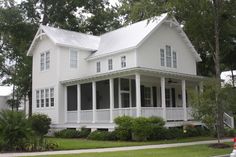 a large white house sitting on the side of a road