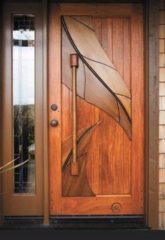 a wooden door with an artistic design on it