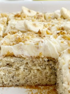 a close up of a cake on a plate with bananas and cream cheese frosting