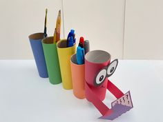 several pencils and markers are lined up in different colors