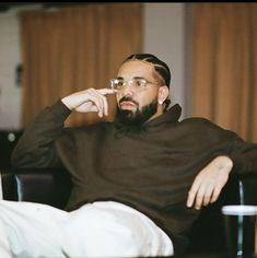 a man sitting in a chair talking on a cell phone