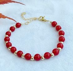 This beautiful and simple design coral red bracelet is made with 6cm bright red carol beads,  4cm 14k gold plated, and 18k gold extension. Length: 16cm with 5 cm extension.  This bracelet is ready and can be posted in 1 working day by royal mail 2nd class. It will be packed with a gift box and ready to be gifted.  More can be found:  http://www.etsy.com/uk/shop/smartsmalldesigns Red Bracelet, Red Bracelets, Coral Red, Gift Christmas, Bright Red, Arm Band, Simple Design, Uk Shop, Royal Mail