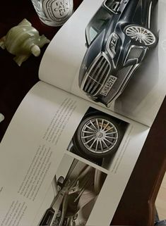 an open book with pictures of cars on it and the pages are folded in half