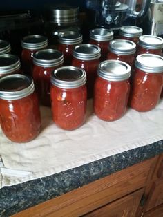 many jars are lined up on the counter