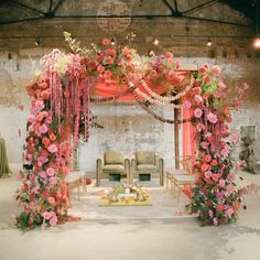 a decorated stage with chairs and flowers on it