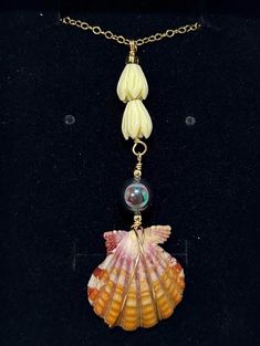 This beautiful yellow Hawaiian sunrise shell is accompanied by a gorgeous peacock mother of pearl and some pikake beads! This amazing combination is showcased on a dainty 18 inch 14k gold filled chain.  Check out all the other amazing shell jewelry in my shop! https://scubastevedesigns.etsy.com I dive Hawaiian waters searching for the most beautiful shells to turn into jewelry that is unique to the Hawaiian islands. My shells are found from 60 - 120 ft deep. I personally collect, clean, and wire wrap my shells. Each necklace is durable yet dainty.  (Q9) 18 inch 14k gold filled