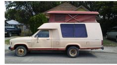 an old camper van parked in front of a house