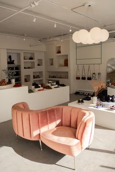 a living room filled with lots of furniture and decor on top of a white floor