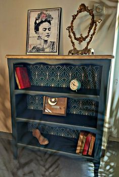 a book shelf with books and pictures on it