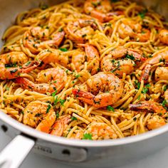 pasta with shrimp and parsley in a pan