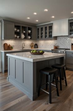 a kitchen with gray cabinets and white counter tops