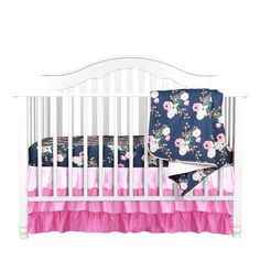 a white crib with pink and blue bedding