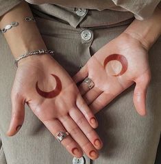 two hands with rings on their fingers are shown in the shape of crescents and stars