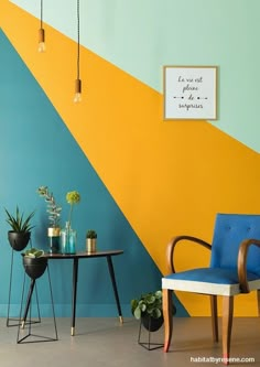 a blue chair sitting next to a table with potted plants on it