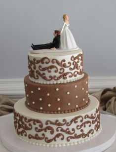 a wedding cake with a bride and groom on top