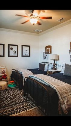 a bed room with a neatly made bed and two pictures on the wall above it