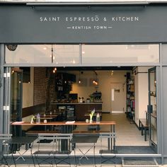 the entrance to a restaurant with tables and benches in it's front door window