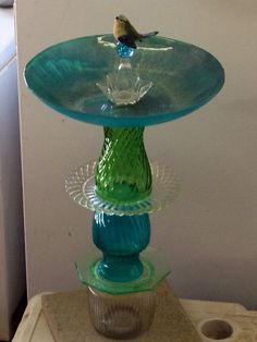 a glass bird bath sitting on top of a pedestal