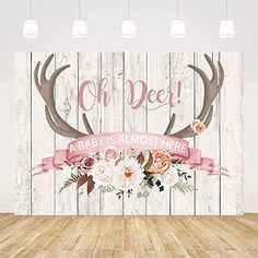 a baby is almost here with antlers and flowers on the wood background wall mural