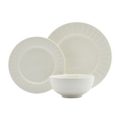 a white dinner set with a bowl and saucer on the side, in front of a white background