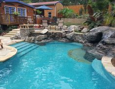 an outdoor pool with steps leading up to it and a deck in the back ground