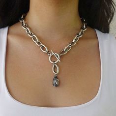 "A beautifulsilver y necklace with a crystal pendant and a  toggle clasp. Crystal color is dark gray \"moon light\". This teardrop necklace has unique eye shaped links.  Easy to match, this teardrop necklace will upgrade any outfit! For reference: model is waering 19'' long necklace Please note: length doesn't include the drop Available in gold plating as well. Materials: Silver plated brass chain and elements - oxidized finish 24 k gold plated brass chain and elements - matte/shiny finish  Meas Silver Teardrop Chain Necklace, Silver Teardrop Clavicle Chain Necklace, Elegant Silver Toggle Necklace With Clavicle Chain, Silver Elegant Toggle Necklace For Jewelry Making, Silver Teardrop Lariat Necklace With Adjustable Chain, Toggle Necklace, Silver Necklace Statement, Moon Light, Silver Chain Bracelet