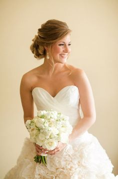 a woman in a wedding dress holding a bouquet