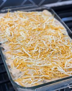 a casserole dish with cheese on top of it sitting on an oven rack