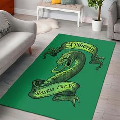 a green area rug with an image of a snake holding a banner on it's side