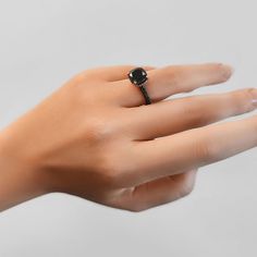 Classic Black Rings With Prong Setting, Classic Black Sapphire Ring With Prong Setting, Formal Black Rings With Black Diamonds, Formal Black Round Cut Rings, Formal Black Diamond Ring With Prong Setting, Classic Black Ring With Halo Setting, Black Round Cut Jewelry For Formal Occasions, Black Diamond Ring With Halo Setting For Formal Events, Black Diamond Ring With Halo Setting For Formal Occasions