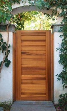 an open wooden door in front of a white wall