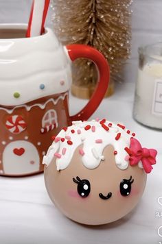 an egg decorated like a cupcake next to a mug