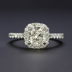 a cushion cut diamond ring with pave set shoulders