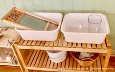 two white dishes on a wooden shelf with cleaning supplies