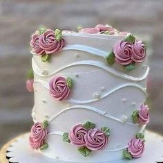 a white cake with pink flowers on it